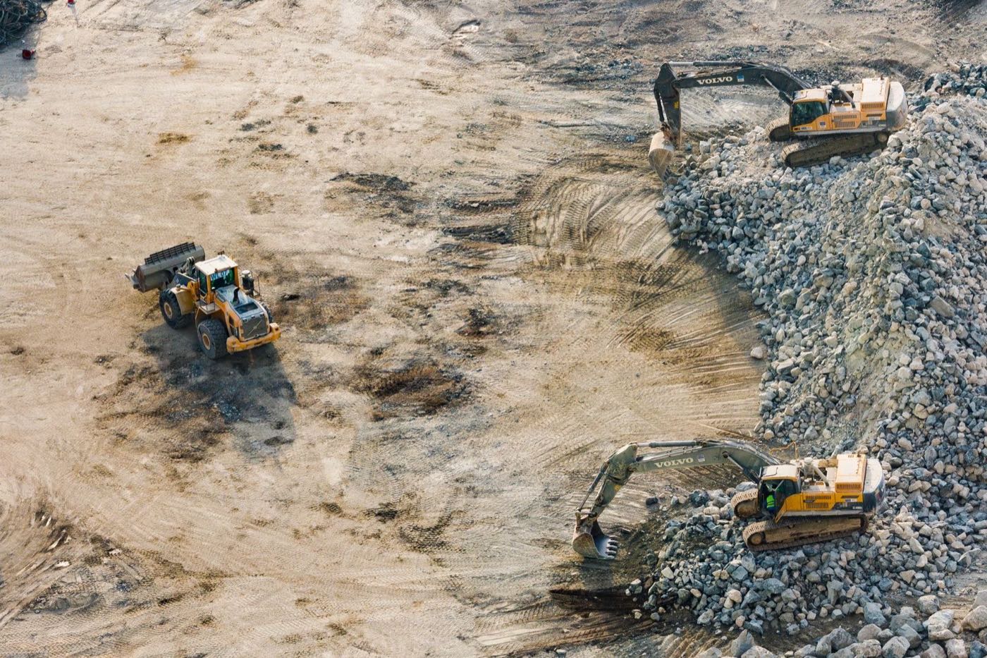 Heavy earth-moving machinery loaded for oversize transport